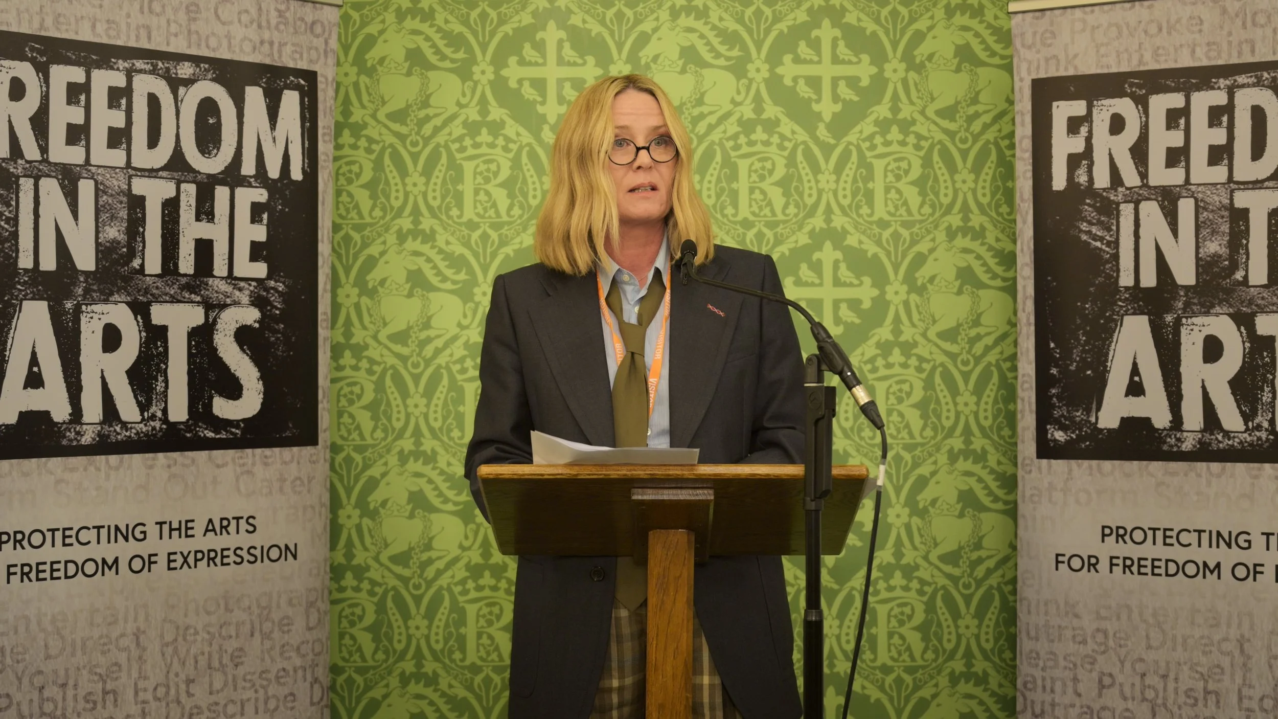 Rosie Kay speaking at the Westminster launch of The New Boycott Crisis, April 2026, flanked by Freedom in the Arts pull-up banners.